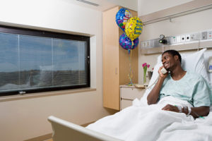 patient on phone in hospital room